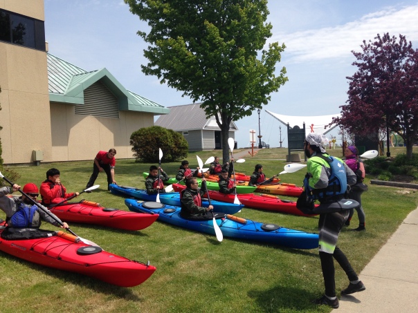 Students learning to kayak before heading out onto the water